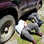 2 men under their vehicle trying to repair it