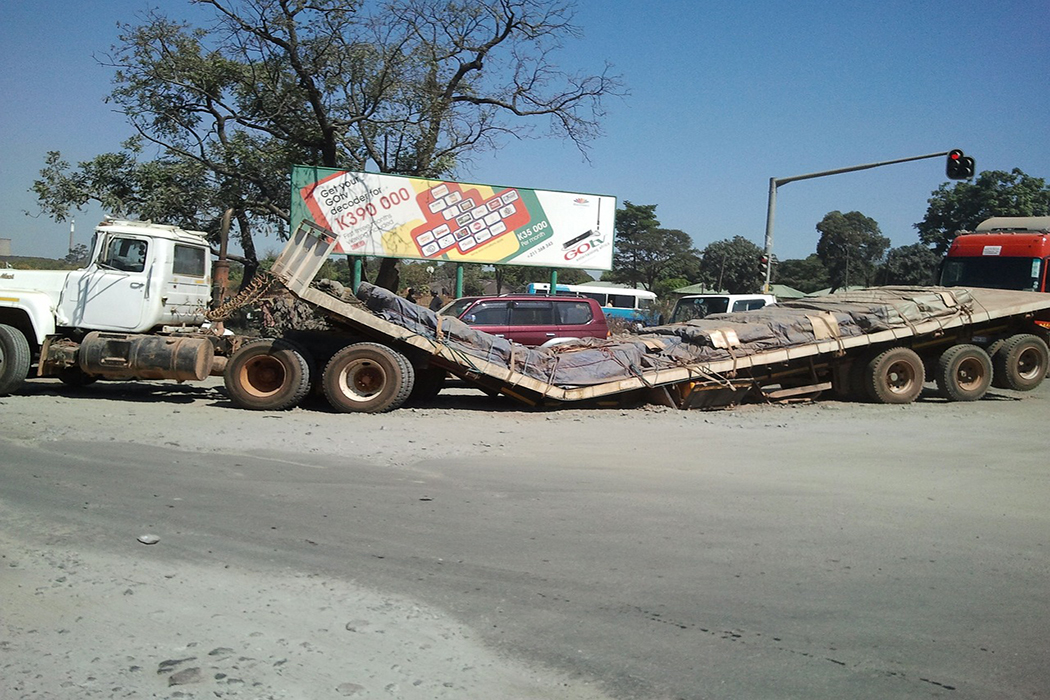 semi truck, where the trailer has snapped in half due to the weight