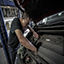 man repairing motor of vehicle