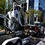 police truck towing a police helicopter on a flatbed