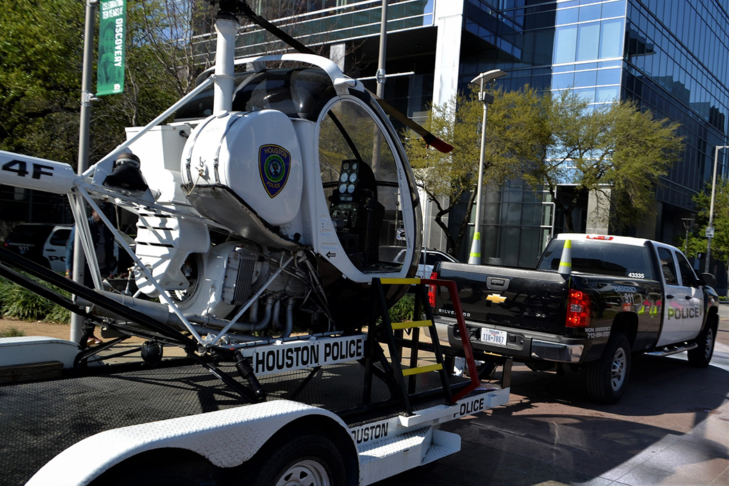 police truck towing a police helicopter